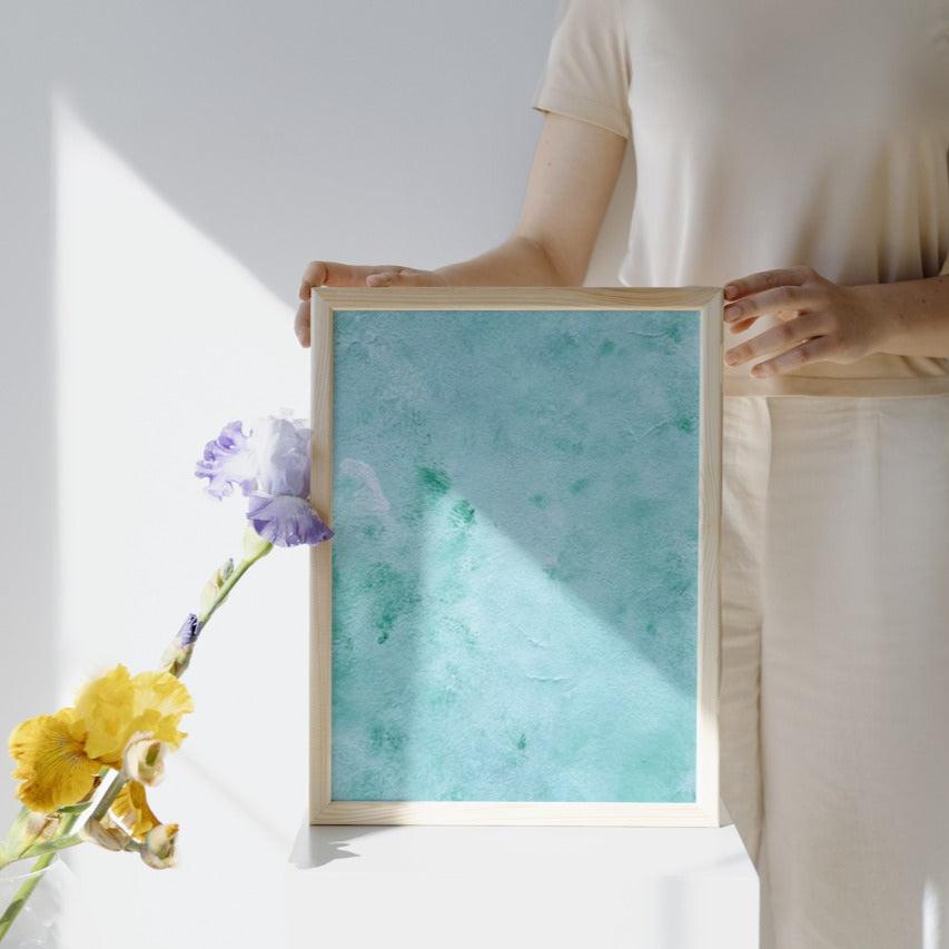 mint, green Feel good one of one-of-a-kind colorful art poster based on original abstract art created by up-and-coming artist Scandinavian Jeanette Haga as decor for modern home held by a woman
