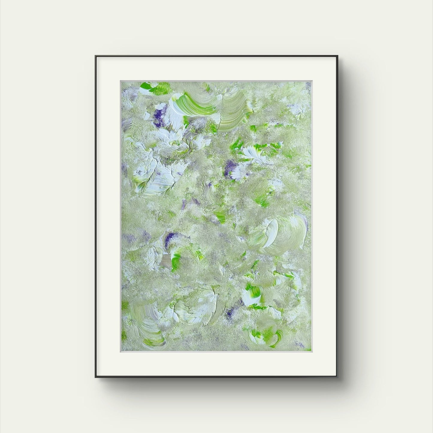 Original one of a kind colorful abstract acrylic art piece in green, purple and white, with a thin black frame, hanging vertically and created by Jeanette Haga as decor for modern homes