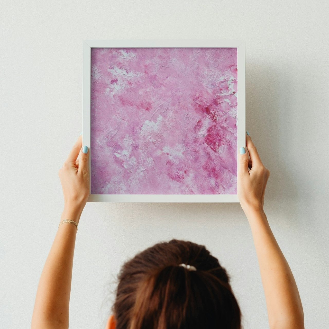 Vibrant Red and white Feel good one of one-of-a-kind colorful art poster based on original abstract art created by up-and-coming artist Scandinavian Jeanette Haga as decor for a modern home held against a white wall