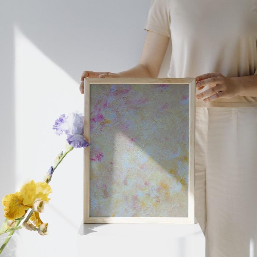 Yellow and pink Feel good one of one-of-a-kind colorful art poster based on original abstract art created by up-and-coming artist Scandinavian Jeanette Haga as decor held by a woman