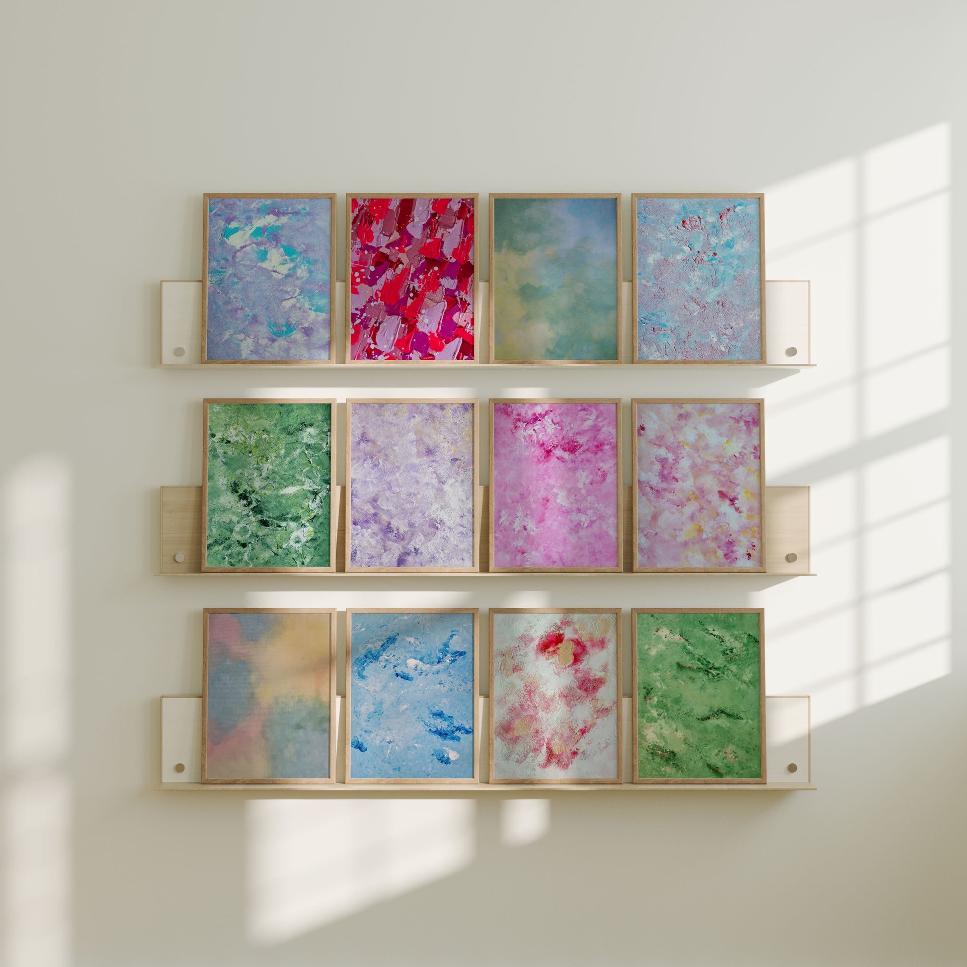 Wall with framed abstract colorful artworks in a grid pattern