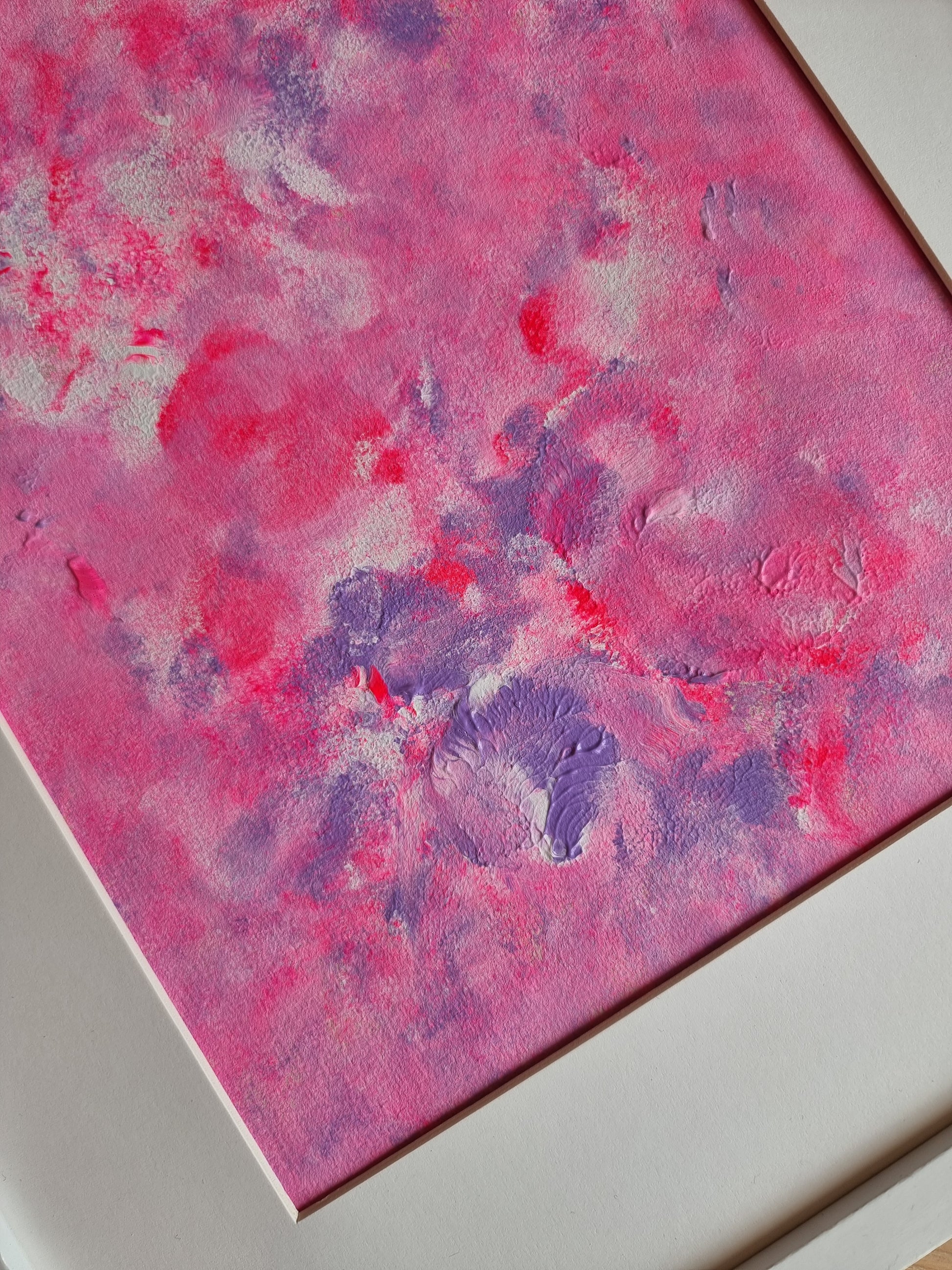 Close up of Pink, purple and white abstract original acrylic painting with a white frame and a white passe-partout