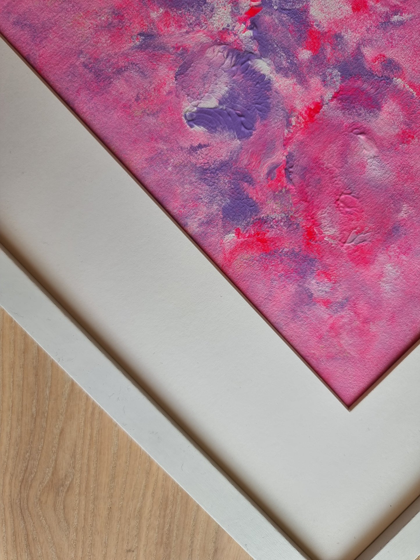 Close up of Pink, purple and white abstract original acrylic painting with a white frame and a white passe-partout