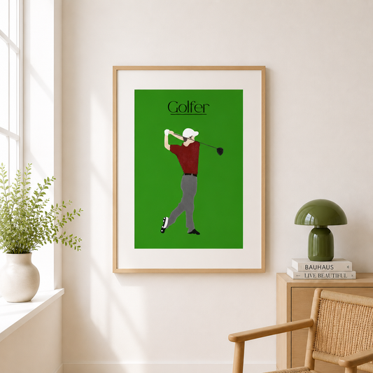 A framed minimalist art print of a golfer on a green background, hanging on a light beige wall in a styled room with a window, plant, lamp, and chair.