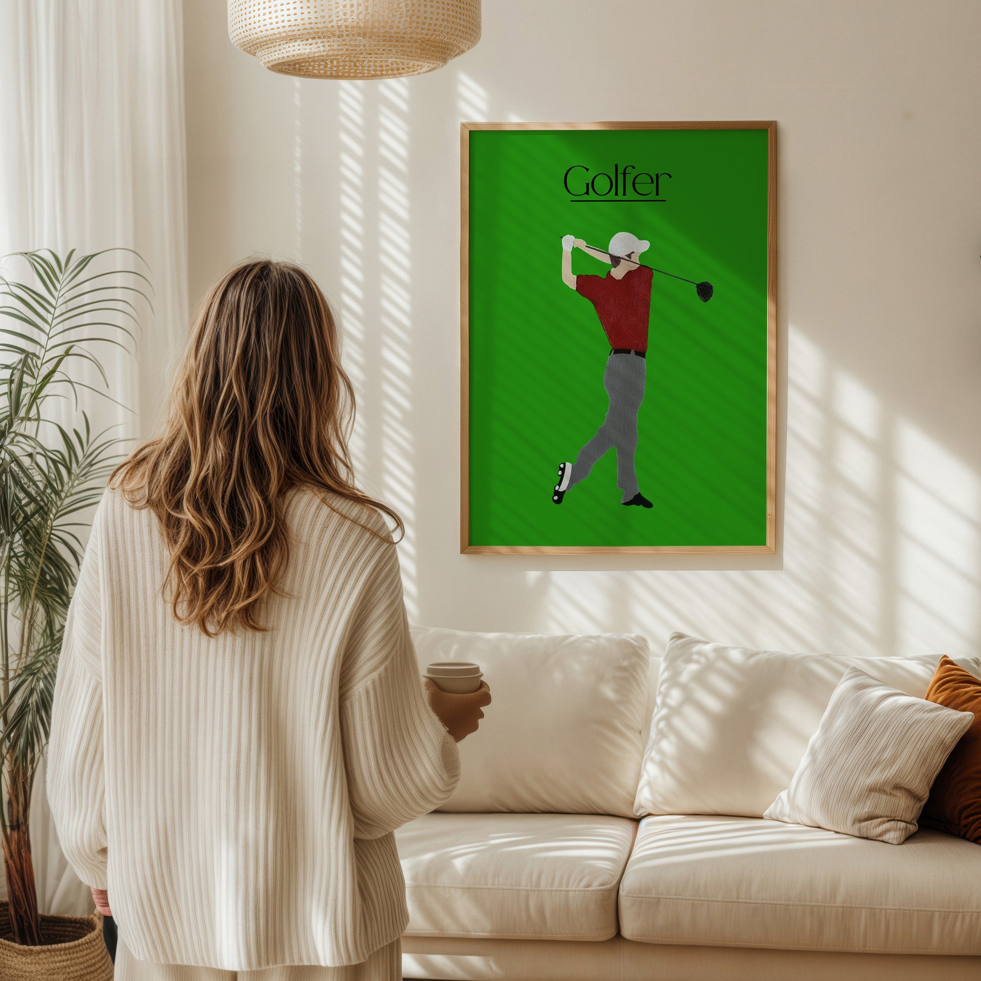 Woman viewing the Golfer Green fine art poster in a bright Scandinavian living room — bold green golf wall art made by Scandinavian up-and-coming artist Jeanette Haga.