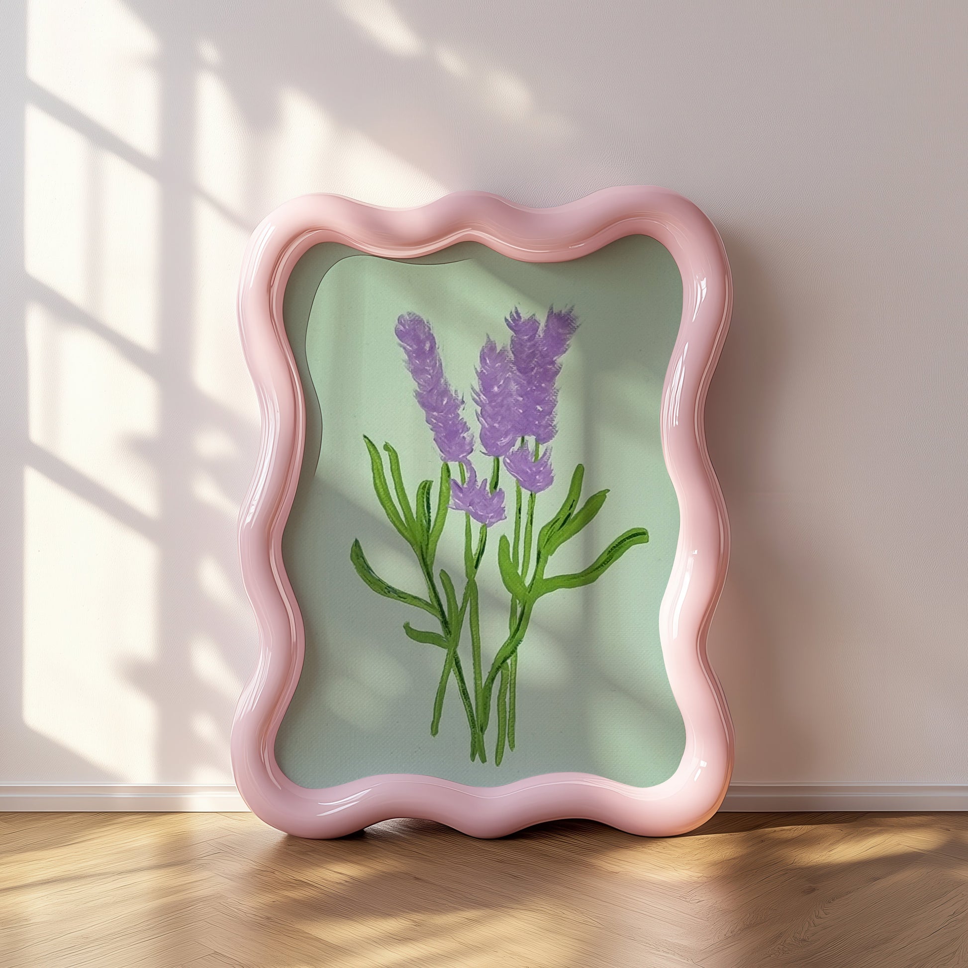 A wavy pink picture frame leaning against a wall on a wooden floor, containing a painted botanical illustration of purple flowers with green stems on a pale mint background.