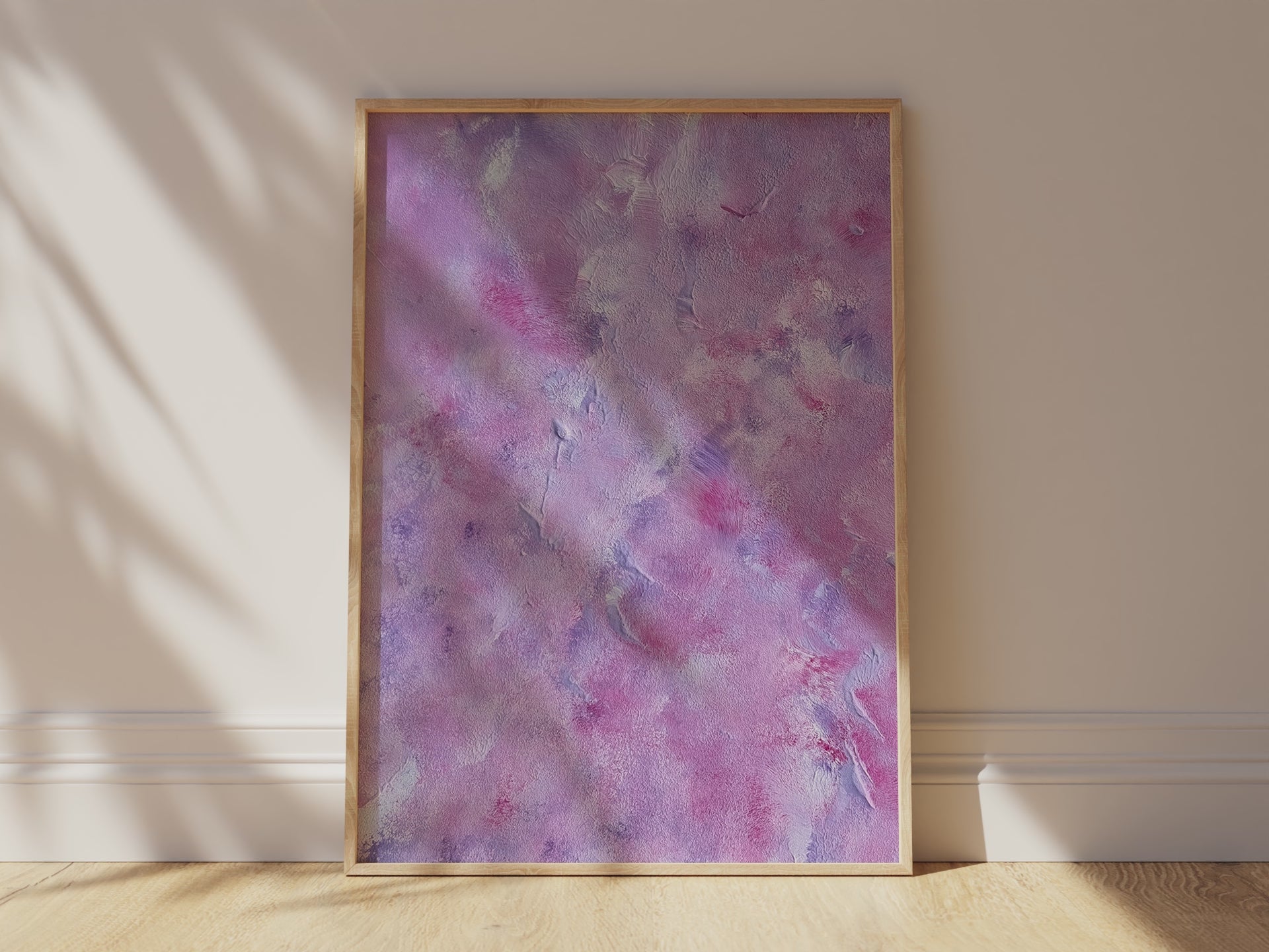 purple and pink abstract art leaning against white wall