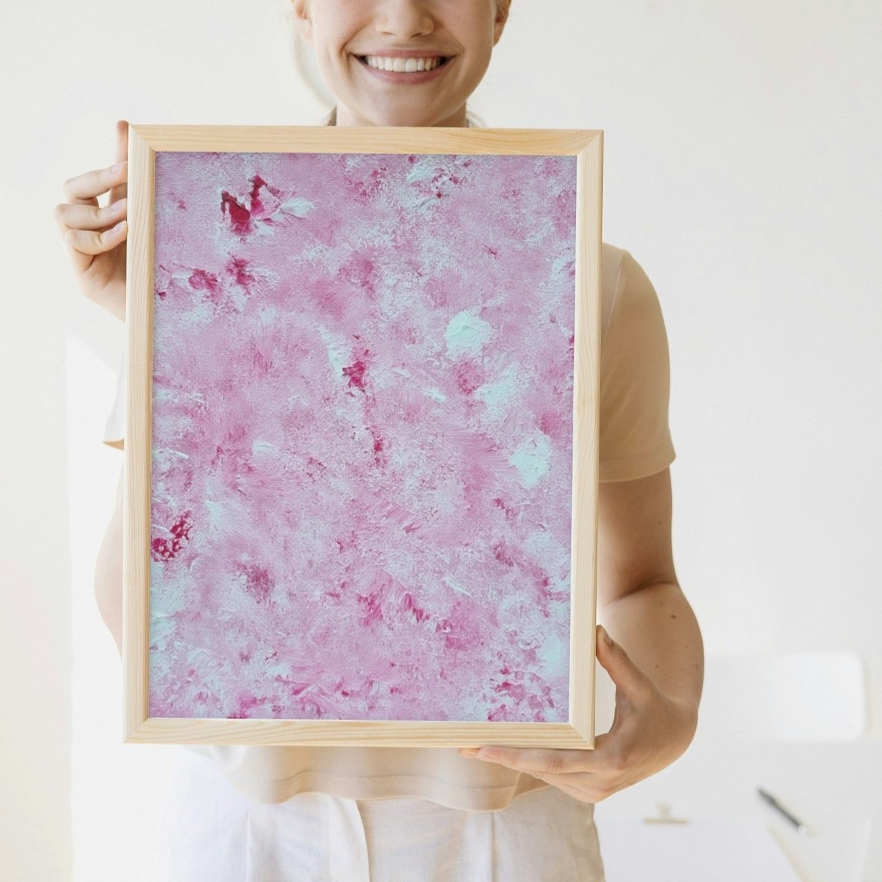 Vibrant Red and white Feel good one of one-of-a-kind colorful art poster based on original abstract art created by up-and-coming artist Scandinavian Jeanette Haga as decor for modern home held by a woman
